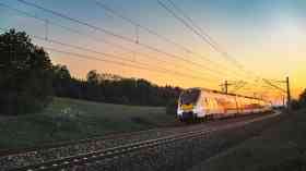 Hi-speed train travelling at sunset.