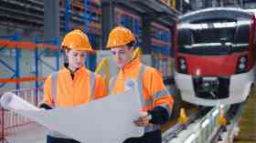 Two engineers in a train factory.