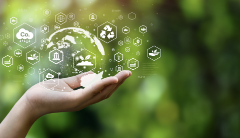 A hand holding symbols of sustainability