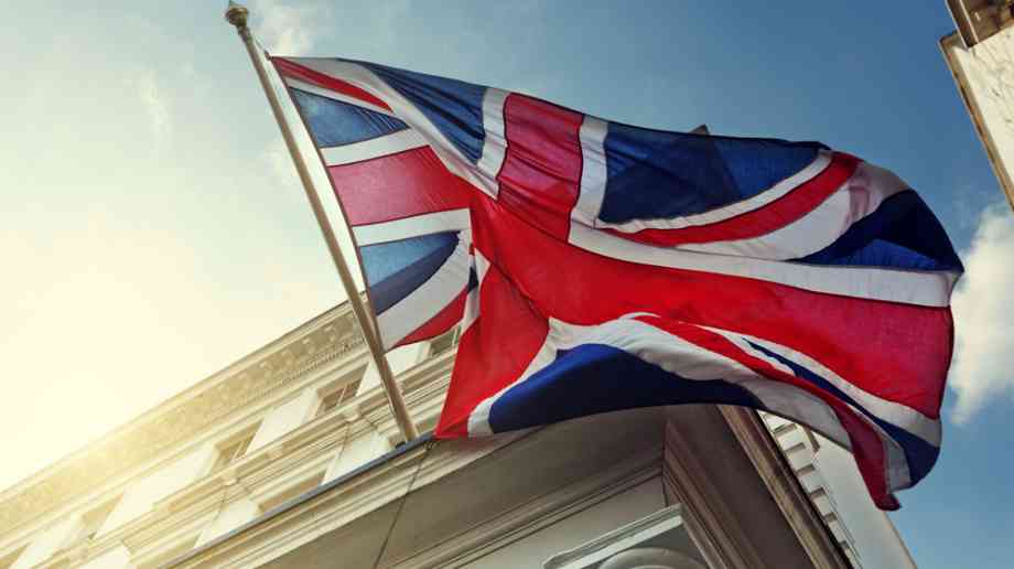 A Union Jack flag blows in the wind. 