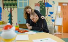 Woman teaching man.