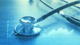 A stephoscope layered over graphics of a line graph with a blue filter.