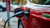 Red electric car being charged